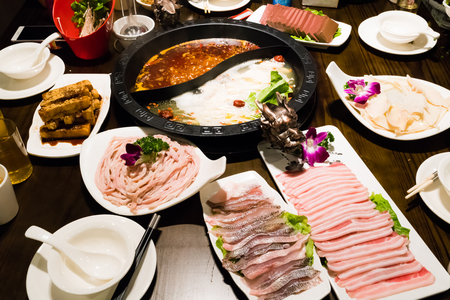 Shabu pot in Chinese style - pork soup and oily spicy soupの写真素材