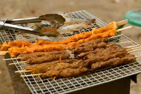 meat, chicken and shrimp barbecue on the charcoal toasterの写真素材