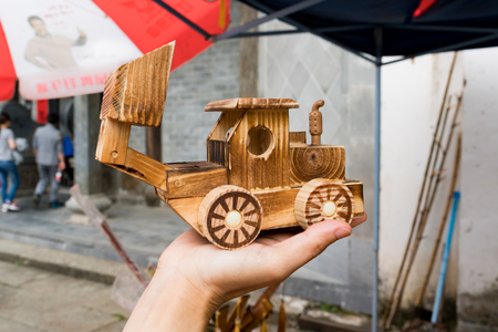 close up wooden backhoe model holding on handの写真素材