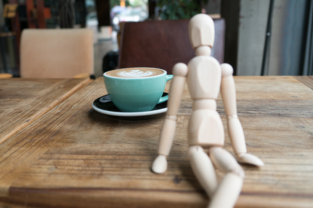 Hot mocha coffee or capuchino in the green cup on the wooden tableの写真素材