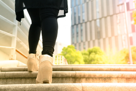 A business women is stepping on stair for successfulの写真素材