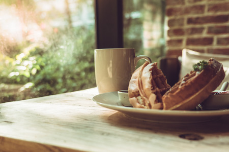 Hot mocha coffee or capuchino with 2 pieces of waffle on the wooden tableの写真素材