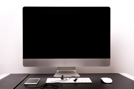 retina display with keyboard, mouse, smart phone and earphoneの写真素材