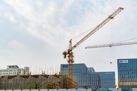 SHANGHAI, CHINA APRIL, 2017 : A crane is working on building construction site at Hi-Tech park industrial estateのeditorial素材