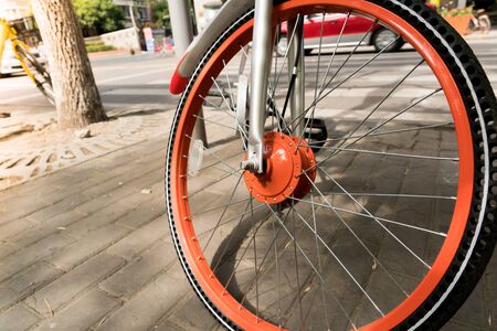 close up the orange bicycle wheel and tireの写真素材