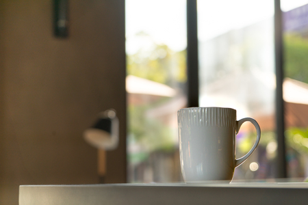 A mocha or cappuccino hot coffee in white cup on the wooden tableの写真素材