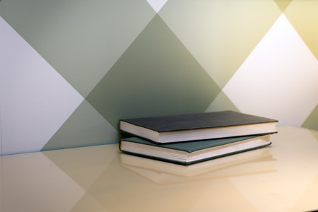 two diary books on the table near graphic wallの写真素材