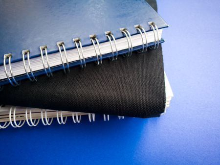 side view stack of book on the blue backgroundの写真素材