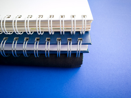 side view stack of book on the blue backgroundの写真素材