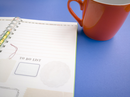 open diary book and pencil on the blue backgroundの写真素材