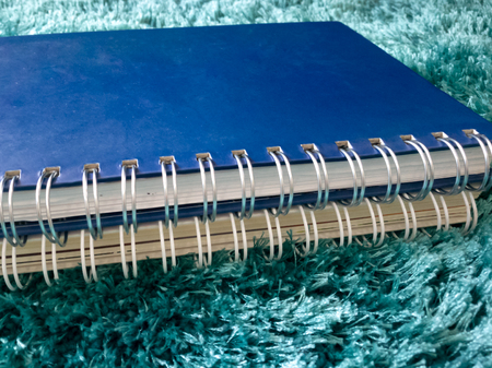 side view stack of book on the carpetの写真素材