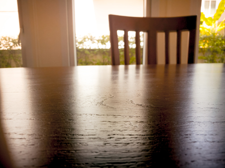 under expose of wooden din table surface and wooden chairの写真素材