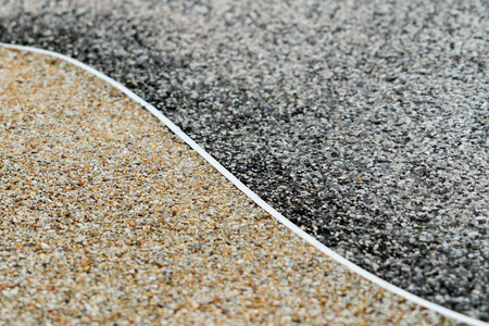 gravel surface texture background, two difference color, dark and gold, yin-yang conceptの写真素材