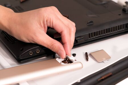 focus on women hand is changing the remote control battery, repair and maintenanceの写真素材