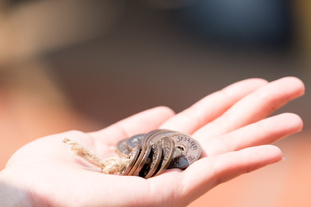 focus on elegant old traditional Thai coin on handの写真素材