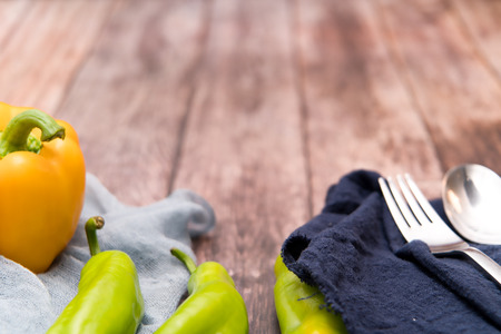 yellow and green bell pepper on the wooden backgrounds with copy spaceの写真素材