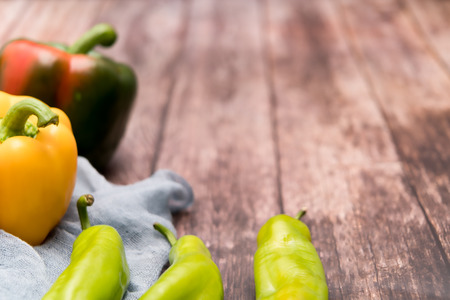 yellow and green bell pepper on the wooden backgrounds with copy spaceの写真素材