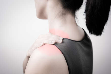 closeup women neck and shoulder pain/injury with red highlights on pain area with white backgrounds, healthcare and medical concept - B&W filterの写真素材