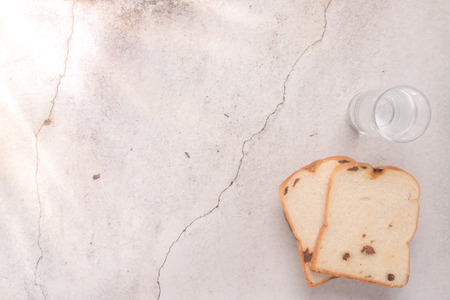 bread and water with sunray on left side food and drink concept with copy spaceの写真素材