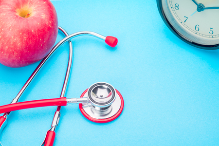 world health day healthcare and medicine stethoscope and red apple healthy and insurance conceptの写真素材