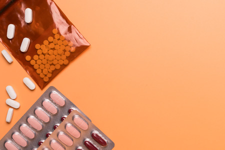 healthcare and medical concept medicine on the orange background with copy spaceの写真素材