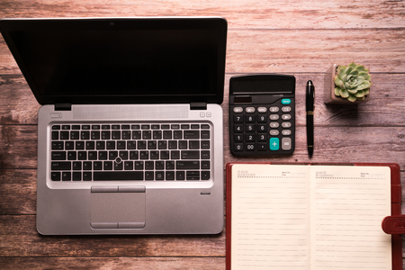 computer laptop and notebook on working table flat lay composition top view  with copy spaceの写真素材