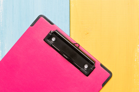 pink clipboard top view on colorful backgrounds with copy space for text