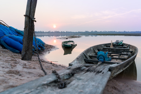 Fishing boat parking on the riverside evening clouds on sunset, Roi Et, Thailandの写真素材