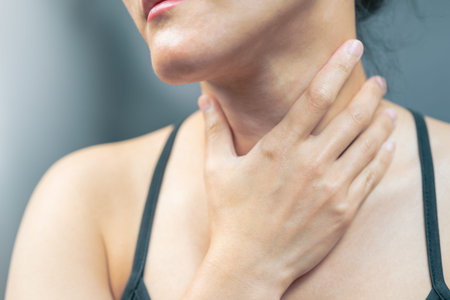 Sore throat pain women. Woman hand touching neck with sore throat feeling bad. Healthcare and medicine conceptの写真素材