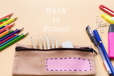 Welcome back to school background, colorful color pencil and stationery bag on yellow backgrounds with copy spaceの写真素材