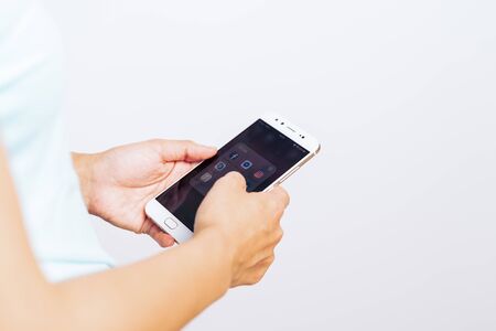 SHANGHAI, CHINA - MAY, 2018 : Women hand using smartphone with icons of social media on screen, smartphone lifestyleのeditorial素材