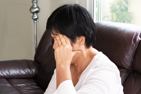 old woman suffering from headache, stress, migraine, health problem conceptの写真素材