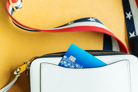 Credit card in white shoulder bag, ready shopping conceptの写真素材