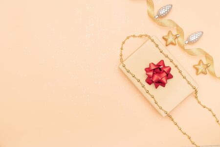 gifts boxes or presents boxes with red bows, star and ball on golden background for birthday, christmas or wedding ceremonyの写真素材