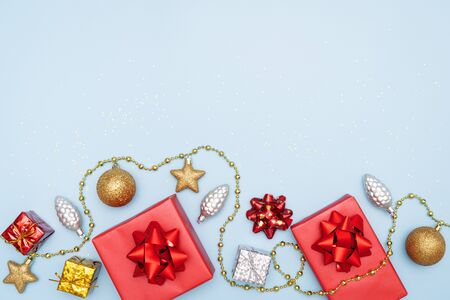 gifts boxes or presents boxes with red bows, star and ball on blue background for birthday, christmas or wedding ceremonyの写真素材