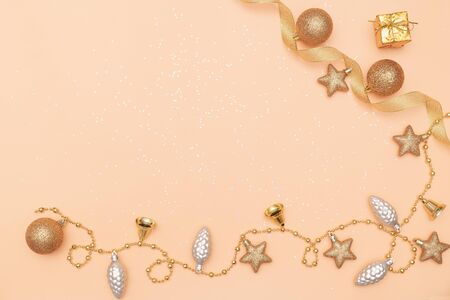 gift box or present box with golden star, bell and ball on golden background for birthday, christmas or wedding ceremonyの写真素材