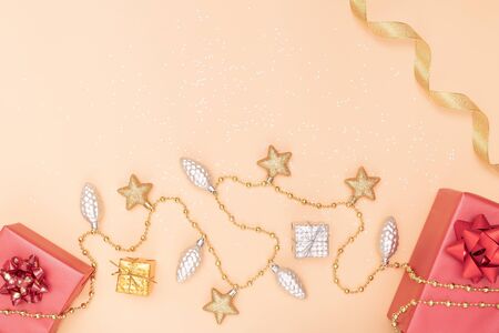 gifts boxes or presents boxes with red bows, star and ball on golden background for birthday, christmas or wedding ceremonyの写真素材