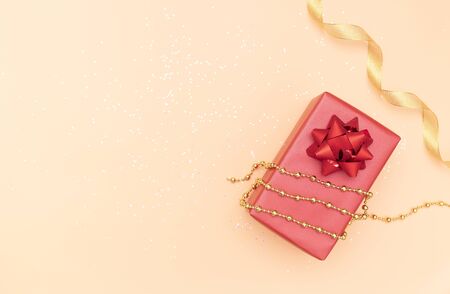 gifts boxes or presents boxes with red bows, star and ball on golden background for birthday, christmas or wedding ceremonyの写真素材