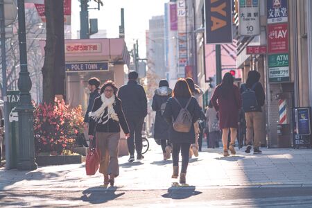 SAPPORO HOKKAIDO, JAPAN - NOV 2018 : people walking on street in rush hour at Susukino District in the winter seasonのeditorial素材