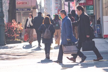 SAPPORO HOKKAIDO, JAPAN - NOV 2018 : people walking on street in rush hour at Susukino District in the winter seasonのeditorial素材