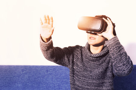 woman wearing virtual reality glasses. Smartphone using with VR headset