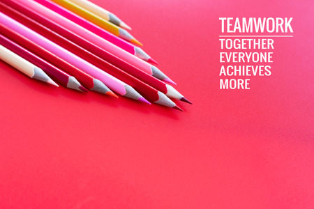 Teamwork concept. group of color pencil on pink background with word Teamwork, Together, Everyone, Achieves and Moreの写真素材