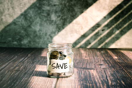 save money, coins in glass jar for money saving financial conceptの写真素材