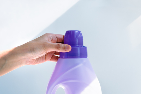 woman hand using liquid laundry softener detergent washing clothの写真素材