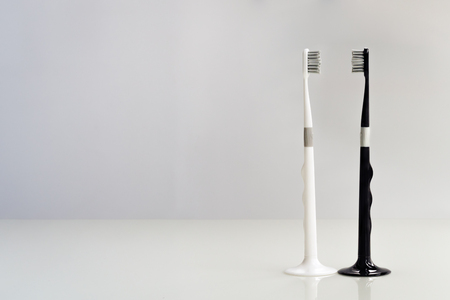couple of black and white toothbrush on gray background, love and cleanの写真素材