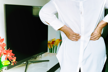 Old woman back pain at home, health problem conceptの写真素材