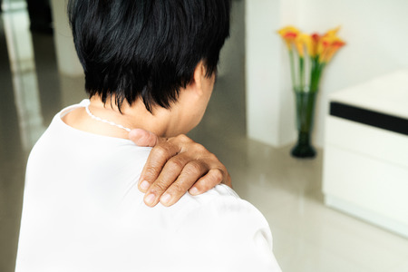 neck and shoulder pain, old woman suffering from neck and shoulder injury, health problem conceptの写真素材