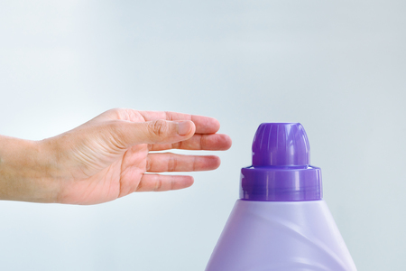 woman hand using liquid laundry softener detergent washing clothの写真素材