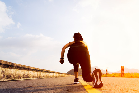 Ready go. running woman on start position and going to run on long roadの写真素材
