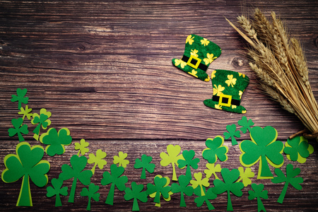 St Patricks day, golden coins, festive hat and green Shamrocks on woodenの写真素材